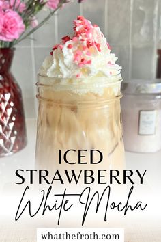 iced strawberry white mocha in a mason jar with whipped cream and sprinkles