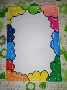 an image of a colorful frame made out of paper with flowers and leaves on it