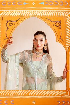 Brand: NeeshayCollection: Neeshay Parinaaz Unstitched Wedding Formal CollectionFabric: Organza PRODUCT DETAILS: Organza Embroidered And Hand Embellished Left Panel (1 Pc) Organza Embroidered And Hand Embellished Right Panel (1 Pc) Organza Plain Dyed Back (1 M) Organza Embroidered And Hand Embellished Sleeves (0.66 M) Organza Embroidered And Hand Embellished Right Panel Border (1 Pc) Organza Embroidered And Hand Embellished Left Panel Border (1 Pc) Organza Embroidered And Hand Embellished Front Border (1 M) Organza Embroidered And Hand Embellished Back Border (1 M) Organza Embroidered And Hand Embellished Sleeves Border (1 M) Organza Foil Printed And Embroidered Dupatta (2 M) Organza Embroidered Dupatta Pallu (2 Pcs) Foil Printed And Dyed Rawslik (5 Yards) DISCLAIMER:* Lining, Laces, and Ta Organza Sharara With Dabka For Reception, Elegant Pista Green Organza Choli, Festive Cutdana Wedding Dresses, Festive Organza Gown With Dabka Embroidery, Transitional Chanderi Dresses For Weddings, Eid Wedding Dress With Cutdana Details, Eid Wedding Dress With Cutdana, Cutdana Wedding Dresses For Eid, Designer Dabka Organza Gown