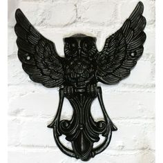 a metal wall hanging with an owl on it