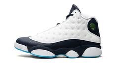 The Air Jordan 13 “Obsidian” is a September 2021 release of the vintage basketball shoe in a color block based on some of the model’s original colorways.  Looking to the Air Jordan 13’s “He Got Game” and “Chicago” styles for inspiration, the “Obsidian” edition of Michael Jordan’s thirteenth signature shoe is complete with a white tumbled leather upper and contrasting paneling, in this case, done up in Obsidian.  The holographic emblem on the collar is a true-to-original design component of the A Sneaker Displays, Retro 7, Retro 9, White Jordans, Vintage Basketball, Air Jordan 13 Retro, Retro 11, Retro 4, Jordan 13 Retro