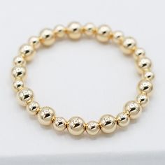 One of our classics from the beaded lux collection. Stack the alternating sized bead bracelet with a chain bracelet for a well-rounded arm party. This style is created with one of our "stretchy" cords for easy wear and effortless bracelet stacking. Bracelet is made with 6mm and 8mm alternating goldfill beads. We want to make sure your stretch bracelet has the perfect fit, so we have created sizing options to select above. Please contact us if you have any sizing questions or would like a custom Classic Hand-strung Stretch Bracelet For Everyday, Everyday Yellow Gold Bracelet With 8mm Beads, Classic 14k Yellow Gold Beaded Bracelets, Classic Adjustable Hand-strung Stretch Bracelet, Classic Beaded Bracelets With Round Beads For Everyday, Elegant 14k Gold-filled Bracelets With 8mm Beads, Elegant 14k Gold-filled 8mm Beaded Bracelets, Classic Beaded Bracelets For Everyday, Classic Everyday Beaded Bracelets