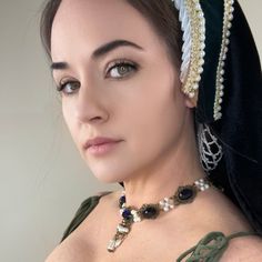 Handcrafted replica period jewelry, made to imitate the style and grandeur of the Tudors. This elegant necklace will complement any renaissance garb, and elevate even the most simple gown into a piece fit for a queen. It is made to order in your choice of gold, silver, or bronze and can be set with resin gemstones of just about any color. Ruby, emerald, sapphire, amethyst and onyx are most popular options.The Elizabeth is made with a row of stunning lace bordered cabochon bases, connected by clustered pearls. 3 Teardrop pearls dangle beautifully from the center cabochon. Tudor Gown, Simple Gown, Period Jewelry, The Tudors, Simple Gowns, Tudor Style, Ruby Emerald, Elegant Necklace, Lace Border