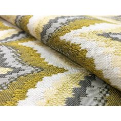 a close up view of a yellow and grey patterned fabric