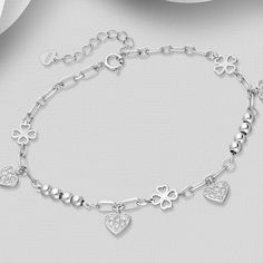 Elevate your elegance with our 925 Sterling Silver Clover Bracelet, featuring a heart design and sparkling CZ diamonds. Adjustable for perfect fit. Bracelet Length: 6½ - 7½" Diamond Heart Charm Bracelet Jewelry, Heart-shaped Cubic Zirconia Diamond Bracelet, Diamond Heart Charm Bracelets For Anniversary, Diamond Bracelets With Heart Charm For Anniversary, Elegant Sterling Silver Heart-shaped Charm Bracelet, Diamond Bracelet With Heart Charm For Anniversary, Fine Jewelry Silver Diamond Heart Bracelet, Fine Jewelry White Gold Heart Bracelet With Cubic Zirconia, Elegant Cubic Zirconia Heart Bracelet With Jubilee Band