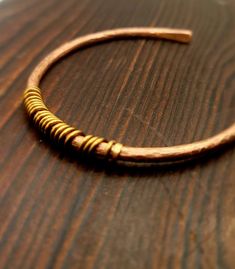 a wooden bracelet sitting on top of a table