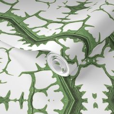 a green and white wallpaper with an abstract design on the back side of it