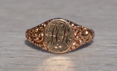 The Trawool:  Baroque and Rococo Era Antique Ring with Hand Engraving in Rose Gold. The ring features the initials HR in the center (which can be removed and re-engraved with your initials for an additional charge on request). On either side of the center is an intricate deeply impressive repousse finish to complete the look. The ring is crafted in rose gold and signed with maker's mark by its craftsman yet we have not identified the maker quite yet. The ring is currently a finger size 6 3/4 yet Elegant Ceremonial Signet Ring With Engraving Option, Luxury Hallmarked Rose Gold Engraved Ring, Elegant Ceremonial Ring With Engraving Option, Formal Hallmarked Rose Gold Engraved Ring, Formal Rose Gold Engraved Ring Hallmarked, Formal Rose Gold Engraved Ring With Hallmark, Elegant Wedding Signet Ring With Intaglio, Luxury Engraved Rose Gold Signet Ring, Elegant Engraved Ring For Ceremonial Occasions