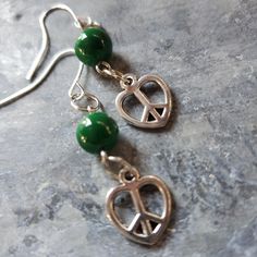 2 Inch Long Silvertone Metal Heart Shaped Peace Sign Charm Earrings. These Earrings And Handmade On Silver Tone Metal Findings With A Green Bead. $8.00 +S&H #Countrygypsyor Silver Heart Beads Metal Earrings, Silver Metal Earrings With Heart Beads, Adjustable Dangle Heart Earrings, Nickel Free, Harry Potter Earrings, Murano Glass Earrings, Bday Gifts, Vintage Gold Earrings, Beaded Drop Earrings, Metal Heart