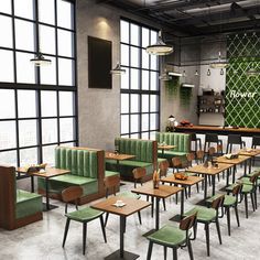 an empty restaurant with green booths and wooden tables