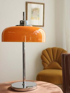 an orange lamp sitting on top of a table