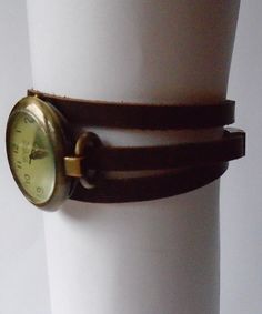 This is a wrap style watch. The case is bronze color metal alloy, free of nickel and lead, round 1.25 inches diameter. The quadrant is vintage style, greenish cream color with numerals. The bracelet will be custom made in crazy-horse distressed finish brown leather 6mm wide. Choose the measure of your wrist and the bracelet will be made with a length 3 times your wrist plus 3/4 inch for room. The closure is a magnetic clasp also made in bronze finish metal alloy. free of nickel and lead. The sty Vintage Handmade Adjustable Watch Accessories, Vintage Watch Bracelet Strap As Gift, Vintage Watch Accessories With Bracelet Strap For Gift, Steampunk Adjustable Quartz Watch, Adjustable Vintage Watches For Gifts, Vintage Adjustable Metal Watch Accessories, Adjustable Brown Steampunk Watch Accessories, Adjustable Steampunk Brown Watch, Vintage Brown Watch Accessories For Gift