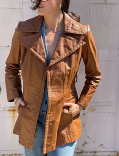 Elevate your style with our exquisite collection of 70s vintage leather jackets for women in tan brown. Crafted from genuine sheepskin leather, our biker bomber jacket exudes timeless elegance and quality craftsmanship. Featuring a belted design, this jacket offers a perfect blend of fashion and functionality, ideal for motorcycle rides or casual outings. Embrace the iconic bomber jacket silhouette with a modern twist, ensuring you stand out in any crowd. Explore our range today and indulge in t Fitted Cognac Outerwear For Fall, Retro Brown Leather Jacket For Winter, Distressed Brown Outerwear With Pockets For Fall, Distressed Brown Fall Outerwear With Pockets, Vintage Distressed Brown Leather Jacket, Retro Brown Leather Outerwear, Vintage Leather Jacket With Long Sleeves For Fall, Fitted Retro Vintage Brown Outerwear, Vintage Fitted Brown Outerwear