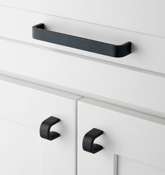 black handles on white cabinet doors and drawers