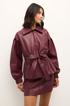 There are some looks from the 80s and 90s we’re happy to leave in the past, but this exaggerated bomber jacket with feminine puff sleeves, long elastic cuffs, and a tie belt with trapunto stitch detailing isn’t one of them. Pictured here in Merlot, our new Chazz jacket looks contemporary and chic paired with our matching Vallie skirt. -Hidden zipper front placket-Drop shoulder with trapunto stitch waist tie belt-Pleated cuff detail-100% polyester-Fully lined-Care instructions: spot clean only Luxury Fitted Leather Jacket With Belt Loops, Modern Belted Leather Outerwear, Vintage Leather Outerwear With Button Closure, Luxury Burgundy Leather Outerwear, Double-breasted Leather Outerwear With Button Closure, Belt Tying, Cuff Detail, Fine Fabric, The 80s