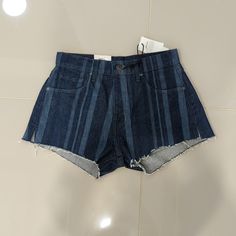 High Rise Dark Denim Shorts With Lighter Denim Strips. Raw Hems With Side Slits. New With Tags, Never Worn. Levi's High Waist Bottoms With Frayed Hem, Levi's High-waist Shorts With Frayed Hem, Levi's Straight Leg Dark Wash Shorts, Levi's Denim Blue Bottoms With Frayed Hem, Levi's Denim Blue Cotton Bottoms, Levi's Denim Jean Shorts For Summer, Trendy Levi's Denim Blue Bottoms, Levi's Straight Leg Cotton Jean Shorts, Trendy Levi's Straight Leg Jean Shorts