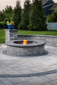 a fire pit sitting on top of a brick patio