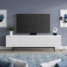 a living room with blue walls and white furniture