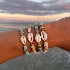 sterling silver or 14k gold filled cowrie shell bracelets  these are water safe for all you beach lovers! each bracelet is made to a standard size and they stretch to fit almost anyone! if you have any concerns about sizing please let me know! each one will be a tad different because of the variation of beads Cowrie Bracelet, Cowrie Shell Bracelet, Ocean Isle Beach Nc, Ocean Isle Beach, Beach Bracelets, Bohemian Beach, Shell Bracelet, Shell Jewelry, Cowrie Shell