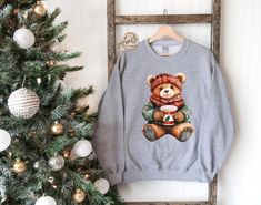 Christmas Bear Sweatshirt, Teddy Bear Hoodie, Cute Christmas Gift, Xmas Teddy Bear Sweater, Christmas Season Apparel, Xmas Toy Sweatshirt CAUTION: For security reasons, there is no rope in the throat area for youth hoodie. Hello!! We wish everyone to smile with our cute, stylish, and trendy graphic sweatshirts and hoodies. We assure you these sweatshirts and hoodies are the perfect gifts whether you buy them for yourself or someone else.  This is not Combo Listing  1. Important Check size chart before you purchase. 2. How to Order *Pick your shirt type and size Your design will be printed on the front.  *Pick your shirt color. 3. Production  Processing time is 1-3 business days. For rush orders please contact us first.  4. Shipping Domestic Shipping First Class 2-5 Business days Priority M Winter Gift Hooded Sweatshirt, Hooded Winter Sweatshirt Gift, Winter Gift Long Sleeve Sweatshirt, Cute Winter Holiday Sweatshirt, Cute Sweatshirt For Holiday Winter, Cute Winter Sweatshirt For Gift, Cute Winter Sweatshirt Gift, Cozy Winter Sweater For Gift, Cozy Winter Sweater Gift