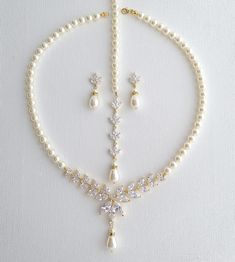 a necklace and earring set with pearls