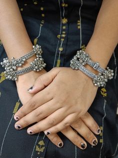 If carefree and confident is the mantra of your life, then boho is the umbrella term for all your fashion choices. Bohemian jewelry with a tribal-inspired look is basically the definition and chic, trendy and elegant, all wrapped in one. This pair of beautiful oxidized kadas is a stunning example of modern German silver jewelry. The bangles come with a bunch of tiny little ghungroos that add an extra dimension to your look. Store away from moisture in a cool, dry place. Umbrella Term, German Silver Jewelry, Silver Handmade Jewelry, Bangles Indian, Black Polish, Handmade Jewelry Gift, German Silver, Bohemian Jewelry, Mantra