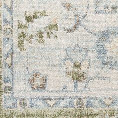 an area rug with blue, green and beige colors