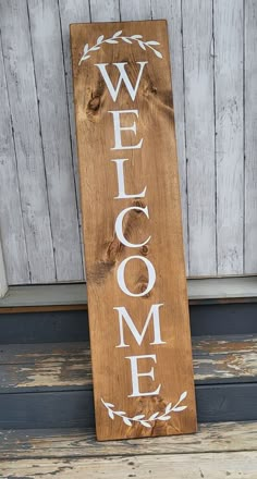 a wooden sign that says welcome on it