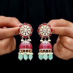 Détails du produit
        Ces boucles d'oreilles jhumka traditionnelles sont un superbe exemple de savoir-faire de style antique. Dotées d'un design de rubis et de diamants polki, ces boucles d'oreilles en rubis respirent une classe et une sophistication intemporelles. Les détails fascinants sont complétés par l'ajout de béryl créé et de gouttes de perles créées, ce qui en fait un bijou vraiment exquis. Ces boucles d'oreilles Dangle feront certainement tourner les têtes et laisseront u Ruby Jhumkas With Intricate Design In Temple Jewelry Style, Ruby Chandbali Jhumkas, Traditional Ruby Chandbali Jhumkas, Traditional Ruby Jhumkas With Tilla, Heavy Ruby Traditional Jhumkas, Traditional Ruby Jhumkas For Festivals, Traditional Ruby Jhumkas With Latkans, Ruby Meenakari Jhumkas Temple Jewelry, Ruby Meenakari Temple Jewelry Jhumkas