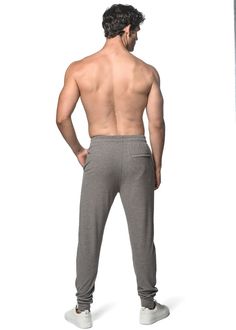 Ultimate comfort meets effortless style in our classic stretch rib knit joggers with a sleek modern fit. Features deep slide front pockets, faux fly detail, interior draw cord, zipped back pocket, dyed to match rib-knit ankle cuffs and relaxed elastic continuous waistband that gently hugs the waist, ensuring a comfortable fit throughout the day. Fabricated from an irresistibly soft, cashmere-like hand feel, viscose/ rayon blend rib knit fabric with a sueded finish, providing butter-like softness Knit Joggers, Rib Knit Fabric, Swim Pants, Viscose Rayon, Fleece Shorts, Ankle Cuffs, Knit Shorts, Short Shirts, Modern Fit