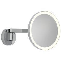 a round mirror mounted on the side of a wall next to a metal arm rest