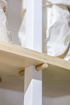 a bag is sitting on top of a wooden shelf