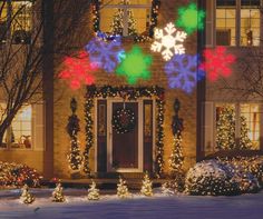 a house decorated with christmas lights and snowflakes