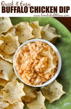 a green plate topped with tortilla chips next to a bowl of buffalo dip