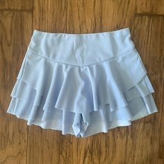 New Without Tags. Medium Ruffle Skort. Blue Stretch Ruffle Skort, Blue Ruffled Stretch Skort, Blue Ruffled Skort For Beach, High Waist Ruffled Skort In Solid Color, High Waist Solid Skort With Ruffles, Beach Skort With Stretch Ruffles, Short Stretch Skort With Ruffles, Beach Skort With Ruffles And Stretch, Stretch Ruffle Skort For The Beach