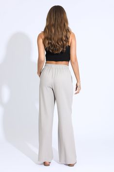 Step into effortless style and comfort with our Wide Leg Beach Pant in a chic taupe hue. These pants are designed for those who crave both relaxation and elegance, making them the perfect addition to your warm-weather wardrobe. Key Features: Fabric Contents: Crafted from a luxurious blend of 80% Rayon, 15% Linen, and 5% Cotton, these pants are soft to the touch and breathable, ensuring all-day comfort in the sun. Flattering Wide Leg Design: The wide leg silhouette offers a relaxed fit that flatt Tie Waist Pants, Skirt Crop, Beach Pants, Leg Design, Tops For Leggings, Cropped Jeans, Jogger Pants, Jeans Shop, Short Tops