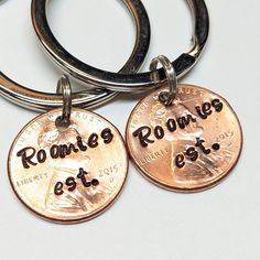 two personalized key chains with one penny and the other is an extra coin for each member