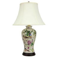 a lamp with a white shade on it and flowers painted on the bottom, along with a black base