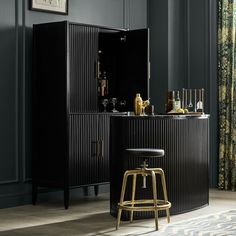 a bar with stools in front of it and an open cabinet next to it