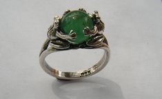 This original design is a sterling silver ring featuring two Frogs holding an 8 mm Aventurine stone. This ring has a solid shank that separates near the Frogs creating a secure mounting that shows the beauty of the stone. The Frogs are completely detailed on all sides and so happy to be holding this beautiful gem stone. Aventurine is widely known as Indian Jade and has the same luster and hardness as green Jade. This is a size 8 ring but I will honor any size request up to US size 13 (22.3 mm in Grass Valley, Green Accessories, Aventurine Stone, Green Rings, Jade Ring, Green Jade, Gem Stone, Piercing Jewelry, Frogs