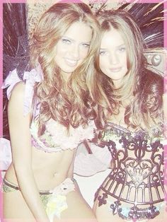 two beautiful young women standing next to each other in front of a pink and white background