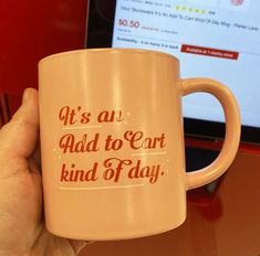 a person holding a coffee mug with the words it's au add to cart kind of day