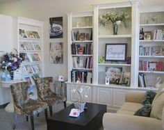 a living room filled with furniture and bookshelves