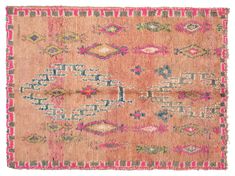 an old rug with pink and green colors