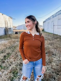 Are you ready for pumpkin spice and Halloween movies? Then this is the top for you! It is the cutest autumn brown color with adorable silver buttons. This top could even be worn as the days turn into winter! Pair it with your favorite blue jeans or a pair of leggings! You could even add a shacket as the weather cools off! This would be the perfect top for a fall festival! Model is 5'7" wearing a small, making this true to size. 95% Polyester, 5% Spandex GENERAL SIZE CHART: 00-EXTRA SMALL, 0-2 SM Brown Buttoned Tops For Fall, Brown Tops With Buttons For Fall, Brown Long Sleeve Top For Everyday, Everyday Long Sleeve Brown Top, Casual Brown Top With Button Closure, Casual Brown Tops With Button Closure, Trendy Brown Tops For Fall, Casual Brown Tops For Fall, Rust Long Sleeve Tops For Fall