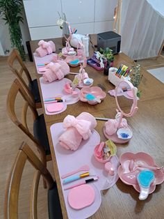 the table is set up with pink items for children's birthdays and baby shower parties