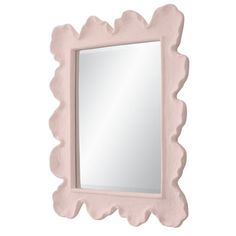 a pink mirror sitting on top of a white wall