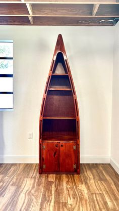 an empty room with a boat shaped bookcase