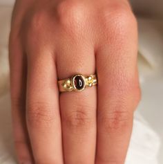 A beautiful organic 18k solid yellow gold ring with hammered surface, about 4.5- 5mm wide and a deep red garnet center stone.  With 3 small golden balls on either side.  This ring is made with sacred geometry and divine numbers.  A very special and unique ring for protection  18k yellow gold  4.5-5mm wide  Weight: About 6g Thickness: about 1mm + a garnet stone - 7x5 Please send a message for a custom order - can be made with any center stone and in any color / karat of gold.  ◈ ENGRAVING is optional for $7 per letter/number/character. Please pay using the engraving order form at this link: https://www.etsy.com/il-en/listing/1067854382/personalisation-engravings?ref=shop_home_active_1&frs=1&crt=1 Please note that engraved jewellery cannot be exchanged or returned ◈ SHIPPING is insured expre Yellow Gold Garnet Signet Ring With Gemstone, Gold Garnet Signet Ring For Anniversary, Gold Oval Garnet Birthstone Ring, Hand Forged Ruby Ring In Red, Hand Forged Red Ruby Ring, Elegant Hand Forged Yellow Gold Ruby Ring, Gold Garnet Rings With Cabochon, Handmade Oval Ruby Ring In Yellow Gold, Handmade Ruby Ring In Yellow Gold