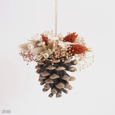 Pine cone ornament with a mix of orange, cream and white dried flowers, grasses and baby's breath. With a yarn loop for hanging.   Approximately 3" x 3 1/2" Dried Orange Christmas Ornaments, Dried Floral Ornaments, Dried Flower Ornament, Dried Flower Ornament Diy, Dried Flower Christmas Ornaments, Dried Flower Ornaments, Orange Dried Flowers, Pine Cone Ornament, Pine Cone Christmas